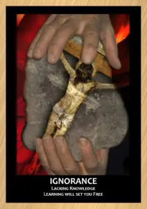 Outward facing hands holding a rock with image of a crucifix on it